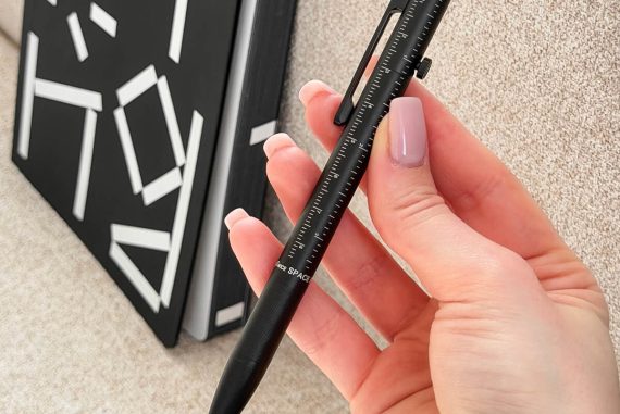 ручка Fisher Space Pen Measure Twice в руці крупним планом